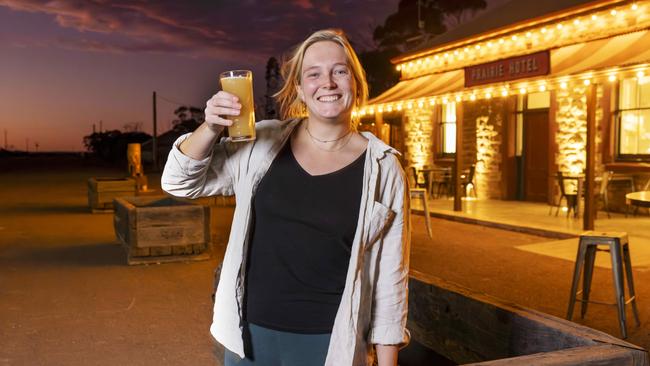 Dutchwoman Sanne Brouwer has her dream job, pulling beers in the outback Prairie Hotel. Picture: Toby Zerna