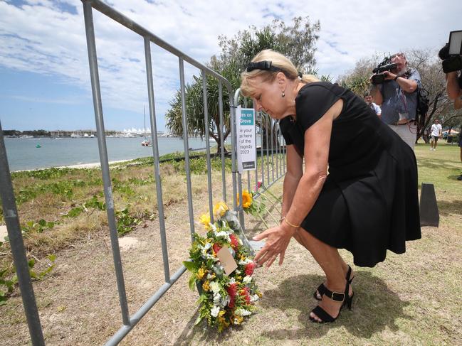 Deputy Mayor Donna Gates lays flowers at the memorial area for the helicopter crash victims at the Broadwater Parklands. Picture: Glenn Hampson.