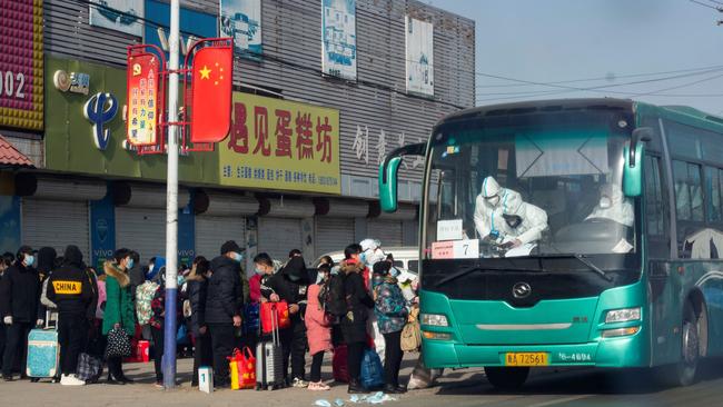 Residents line up to get on a bus at Gaocheng district to be taken to centralised quarantine in Shijiazhuang, in northern China's Hebei province, this week after the district was declared high risk and sealed off. Picture: AFP