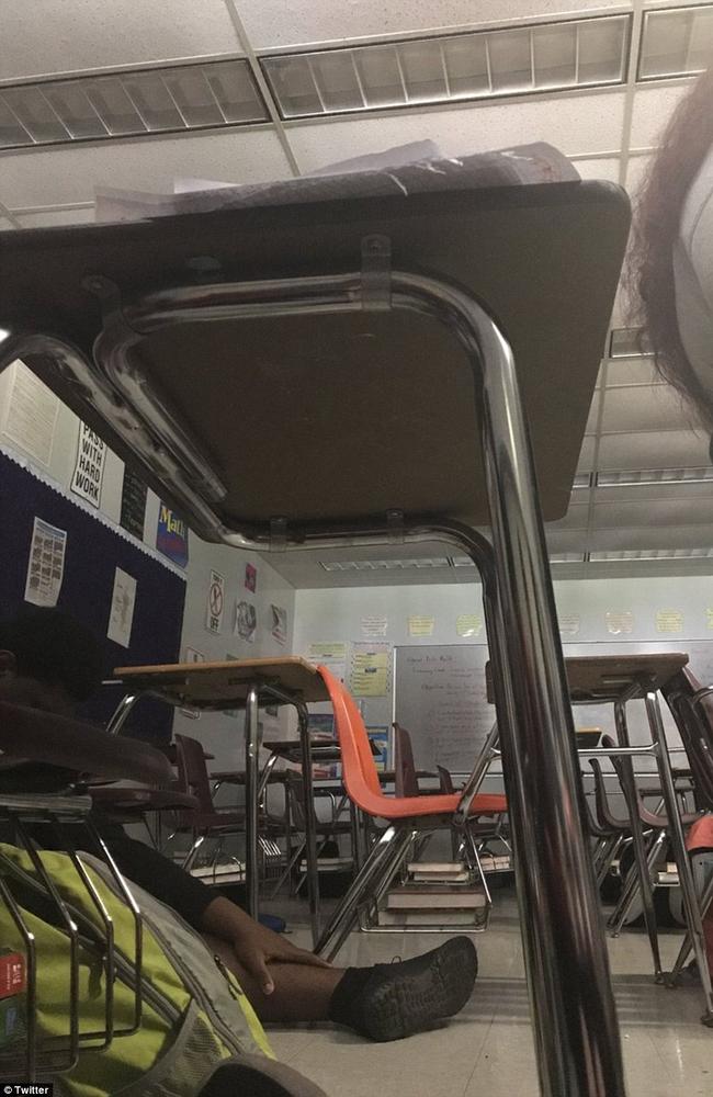 Students hide under chairs and tables of Marjory Stoneman Douglas High School in this picture tweeted by a student as the attack unfolded. Picture: Supplied/ Twitter