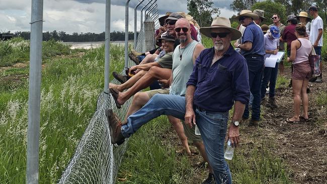 Protesters, above and inset top right, tackle the unwanted fence.