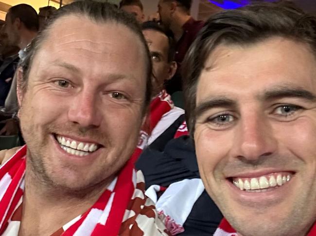 james pattinson and pat cummins watch the swans' prelim final win over port adelaide