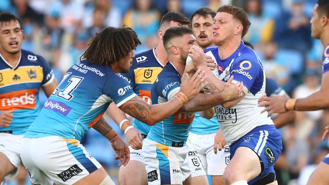 GOLD COAST, AUSTRALIA - MAY 22: Dylan Napa of the Bulldogs is tackled during the round 11 NRL match between the Gold Coast Titans and the Canterbury Bulldogs at Cbus Super Stadium, on May 22, 2021, in Gold Coast, Australia. (Photo by Chris Hyde/Getty Images)