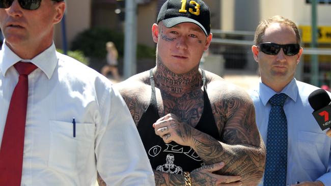 Gold Coast police arrive at Southport Police Station with Ricky Chapman following the Broadbeach Brawl in 2013. Picture: David Clark