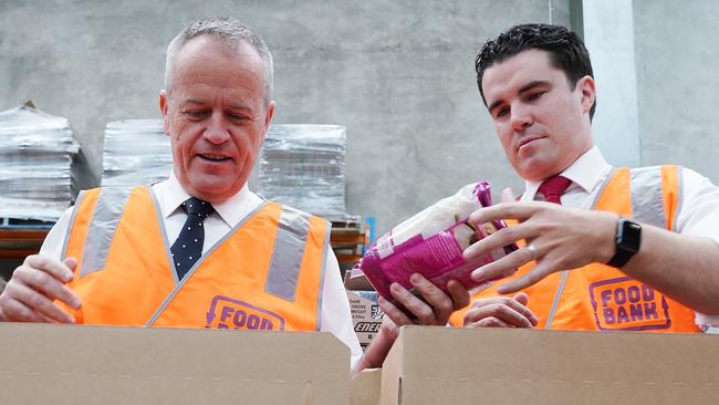 Bill Shorten and Labor MP Tim Watts pack boxes at Foodbank in Melbourne yesterday. Picture: AAP