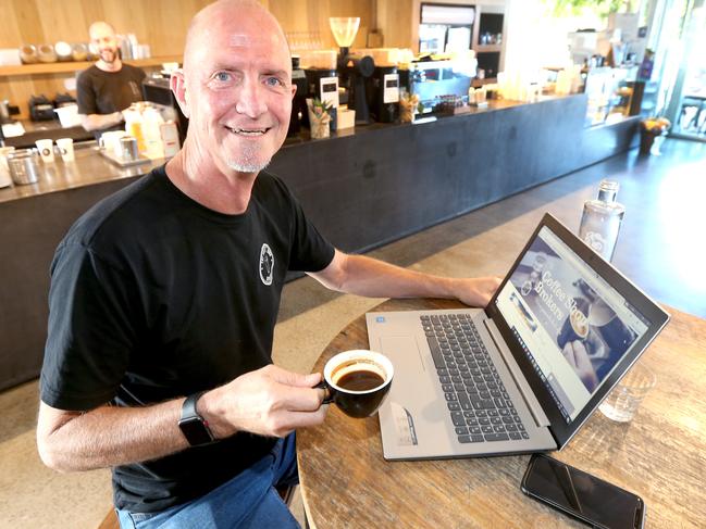 Gold Coast coffee shop broker Craig Louw works on his laptop from coffees shops including Blackboard Coffee at Varsity Lakes. Picture Mike Batterham