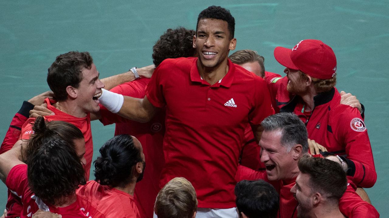 Canada’s Felix Auger Aliassime (centre) celebrates with teammates after winning the Davis Cup final. Picture: AFP