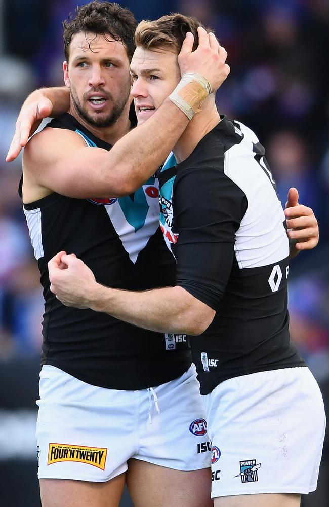 Travis Boak and Robbie Gray of the Power celebrate a goal.