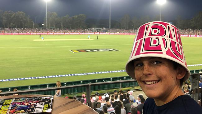 A buckethead enjoys the magic of a Big Bash match in Coffs Harbour earlier this year.