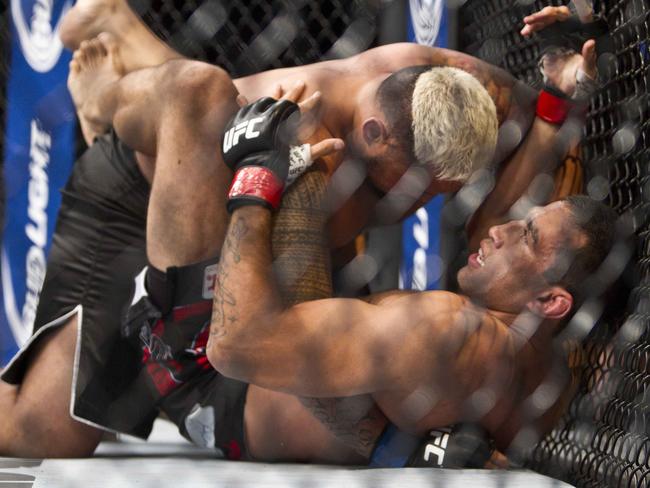 New Zealand's Mark Hunt, top, battles against Brazil's Fabricio Werdum from during a UFC 180 interim Heavyweight title fight in Mexico City
