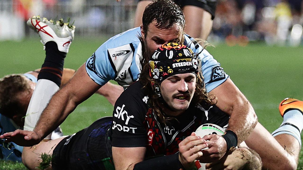 Josh Curran got past Wade Graham and Matt Moylan to score one of the six tries the Warriors grabbed down Cronulla’s left edge. Picture: Dave Rowland/Getty Images