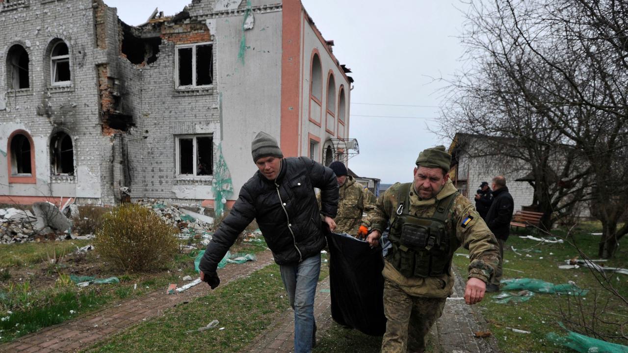 Rescuers carry a body in the village near Kyiv. Picture: AFP.