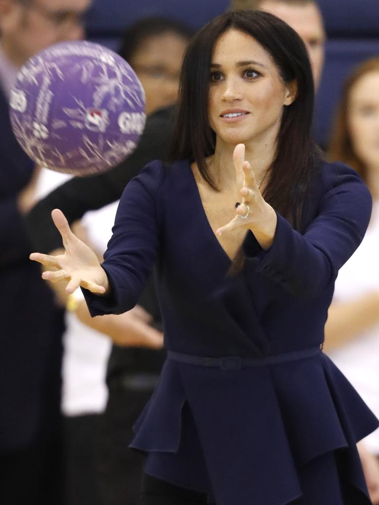 Meghan shows off her athletic prowess during a game of netball. Picture: Getty Images