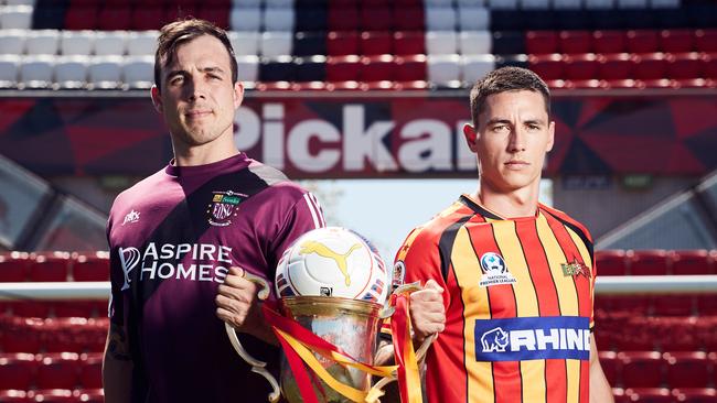 Elizabeth Downs’ Matt Watson, pictured last year with Liam Wooding and the FFA Cup SA, will be hoping to help his side win another Sunday Premier Division amateur title this year. Picture: AAP/Matt Loxton