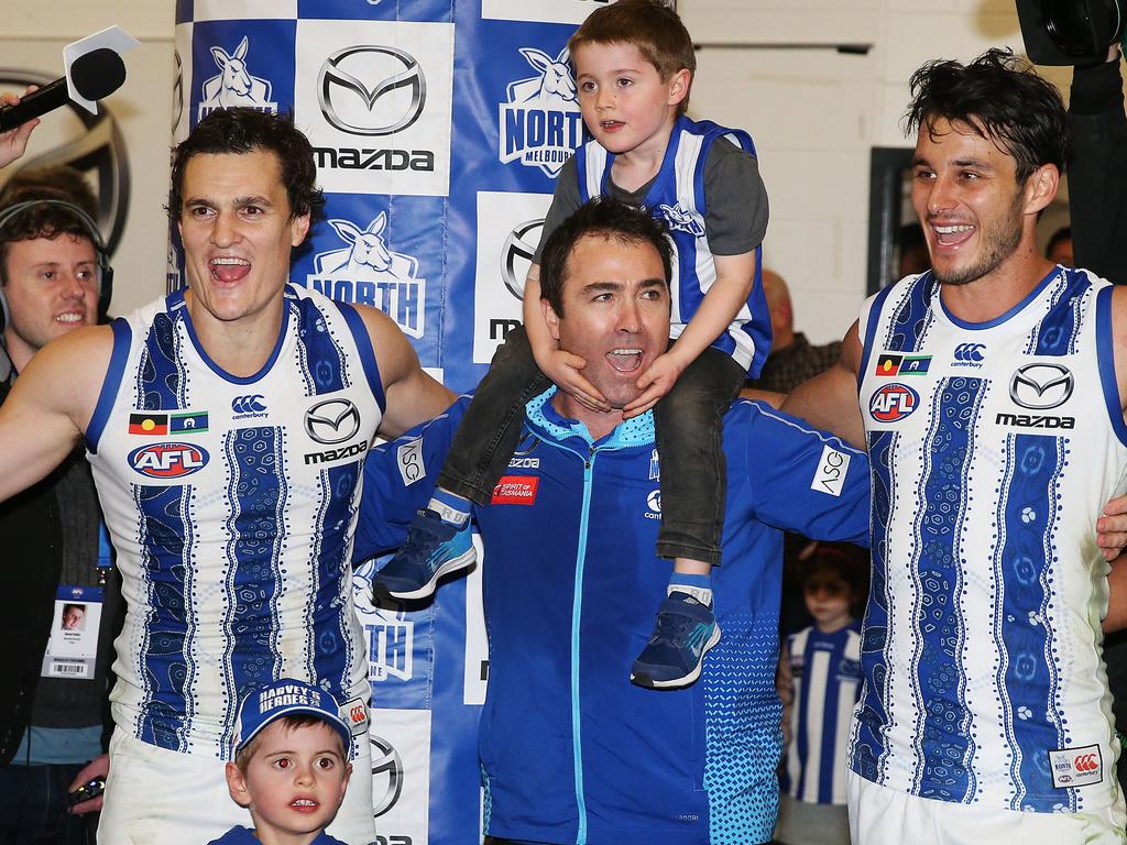 Defensive linchpins Scott Thompson (left) and Robbie Tarrant (right) celebrate a victory with North Melbourne team of the century (so far) coach Brad Scott in 2019. Picture: Getty Images