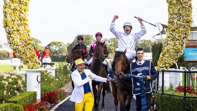 Neil Paine (foreground, yellow pants) was banned by stewards for a month after breaching coronavirus regulations in Sydney for hugging trainer Adrian Bott after the stable won the Golden Slipper with promising two year old Farnan in March 2020. Picture: Jenny Evans/Getty Images.