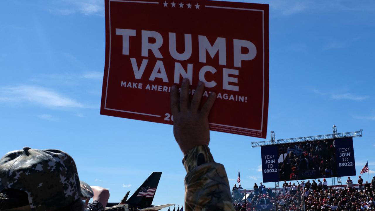 A supporter holds up a campaign sign as US President and Republican presidential candidate Donald Trump speaks at a campaign rally at the Central Wisconsin Airport in Mosinee, Wisconsin, on September 7. Picture: Alex Wroblewski/AFP