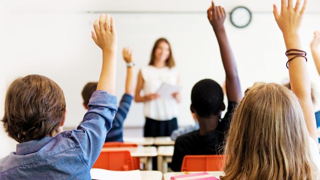 School kids in classroom. Generic (stock) photo of children in a classroom with teacher in background.Picture: iStock