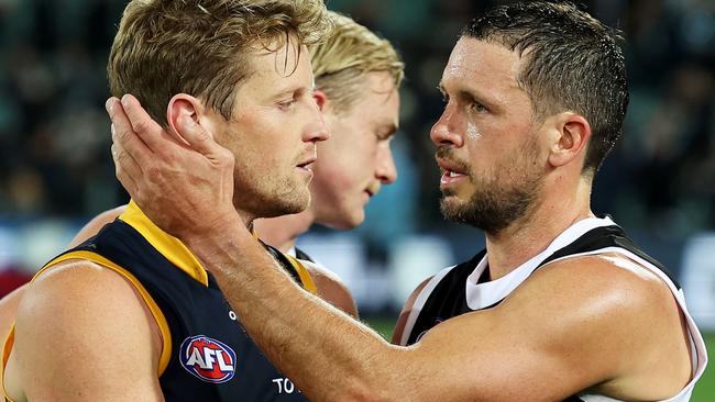 Rory Sloane of the Crows is congratulated by Travis Boak of the Power during the round 3 match between the Port Adelaide Power and the Adelaide Crows at Adelaide Oval.