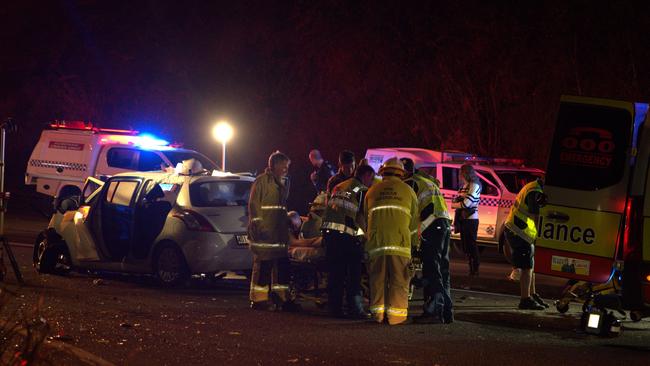 QFD Fireys and QAS paramedics work on injured teenagers after the crash.