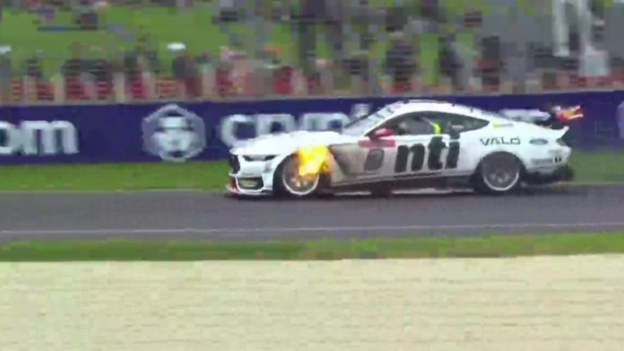 Flames can be seen at the front wheel of Nick Percat's Mustang as he heads to the pits.