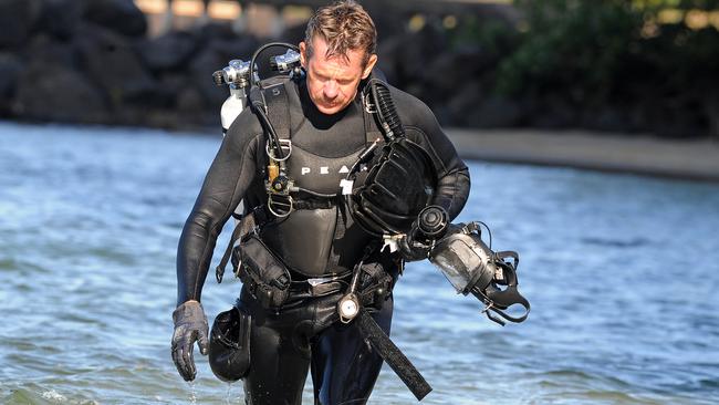 Police divers search for evidence at Jack Evans boat harbour yesterday. Picture: AAP