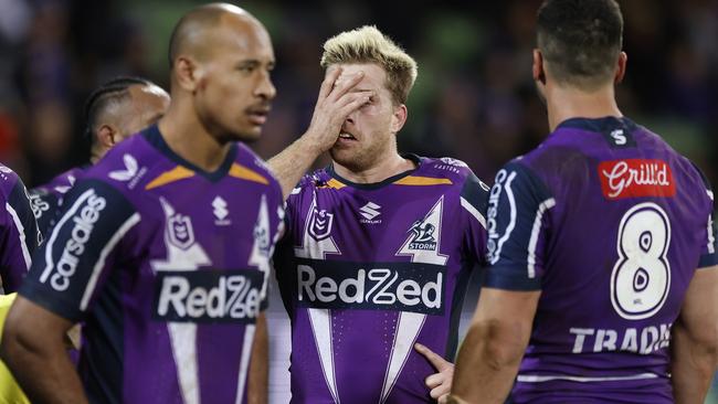 MELBOURNE, AUSTRALIA – JULY 17: Cameron Munster (C) of the Storm reacts with teammates during the round 18 NRL match between the Melbourne Storm and the Canberra Raiders at AAMI Park, on July 17, 2022, in Melbourne, Australia. (Photo by Mike Owen/Getty Images)