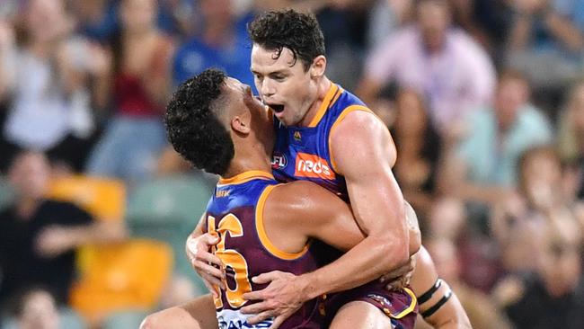 Lachie Neale jumps on teammate Cam Rayner after kicking a goal. Picture: AAP