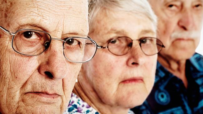 These three elderly people - one woman and two men - look at the camera frowning seriously in annoyance, showing their disapproval and disappointment.