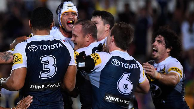 TOWNSVILLE, AUSTRALIA - MARCH 30: Johnathan Thurston of the Cowboys celebrates with team mates after kicking the winning field goal during the round four NRL match between the North Queensland Cowboys and the Melbourne Storm at 1300SMILES Stadium on March 30, 2015 in Townsville, Australia. (Photo by Ian Hitchcock/Getty Images)