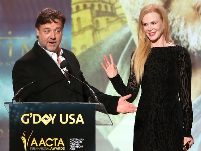 Russell Crowe accepts an award from host Nicole Kidman onstage during the 2015 G'Day USA GALA featuring the AACTA International Awards. Picture: Getty