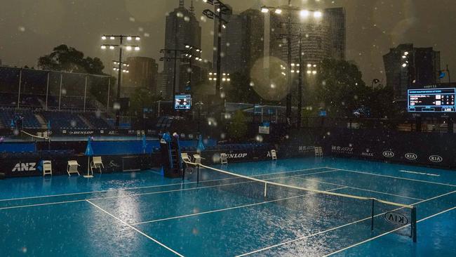 Heavy rain falls at Melbourne Park on Wednesday. Picture: AAP