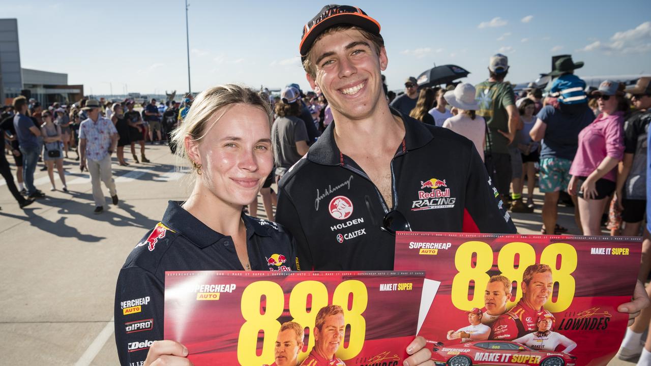 Craig Lowndes fans Caitlyn Mooney and Brendan Scotney as V8 Supercars team Red Bull Ampol Racing launch their 2024 livery at Toowoomba Wellcamp Airport, Saturday, February 3, 2024. Picture: Kevin Farmer