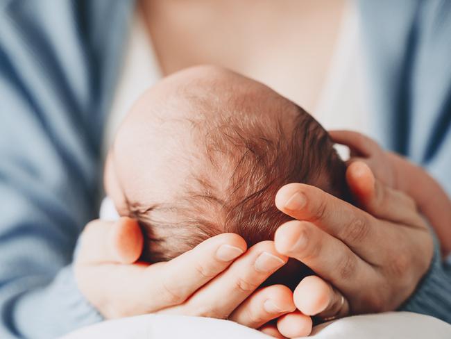 Newborn in mother's hands. Baby care. Childbirth and motherhood concept. Mother and baby