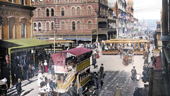 Bringing Adelaide's History to Colour Photography Exhibition - A scene of Beehive Corner bustling with life.