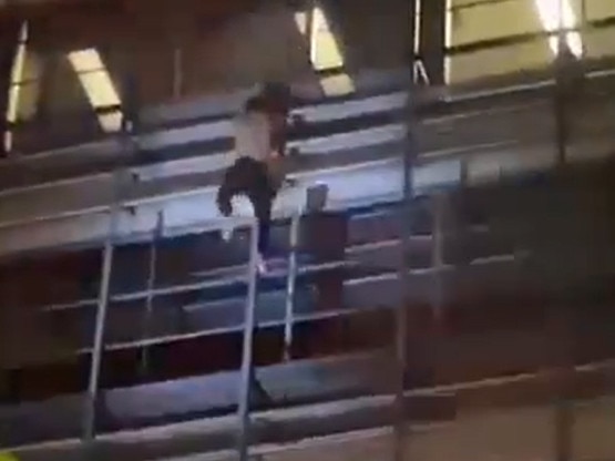 A man scales the eight-storey TCG Centre building in the Darwin CBD yesterday. Picture: Screenshot from supplied video