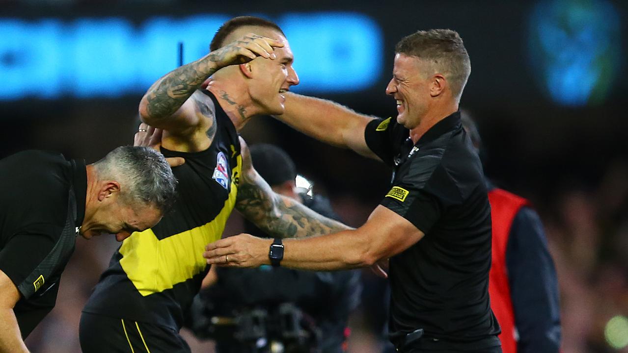 Dustin Martin embraces coach Damien Hardwick after Richmond’s Grand Final win.