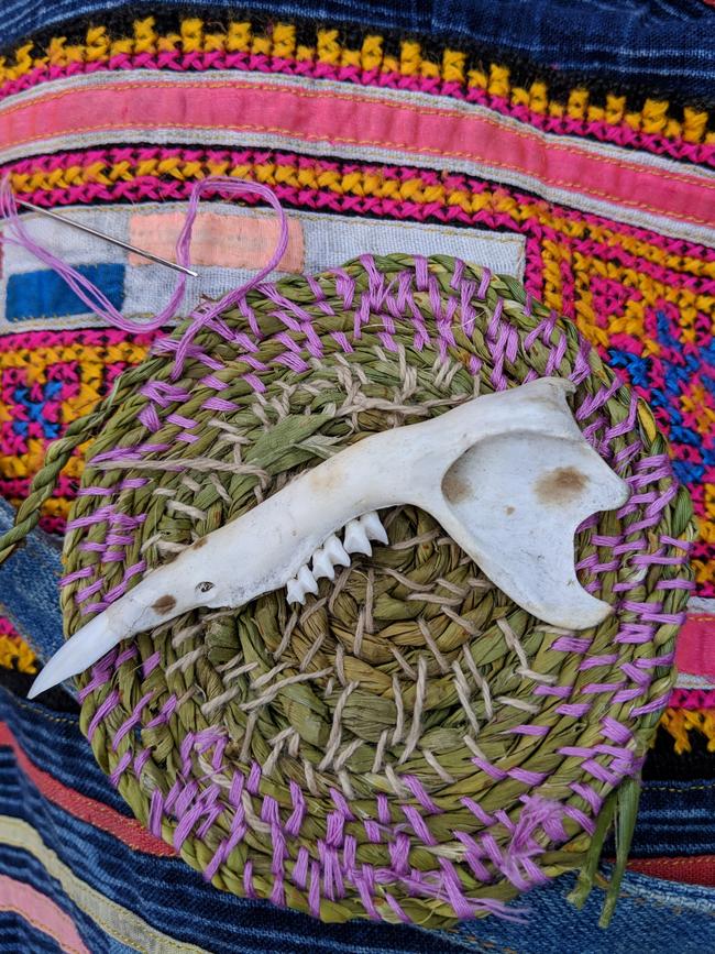 The author cannot be separated from her reed-basket craft to go dancing. Found bone comes in handy later as a lino-cut tool at another workshop. Picture: AMANDA DUCKER