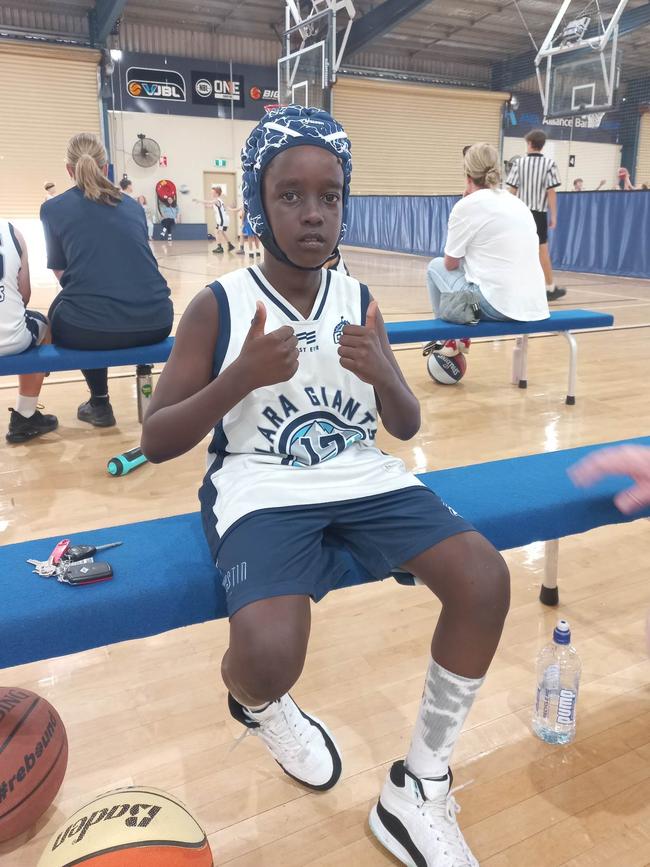 Leon wearing a helmet for protection while playing basketball.