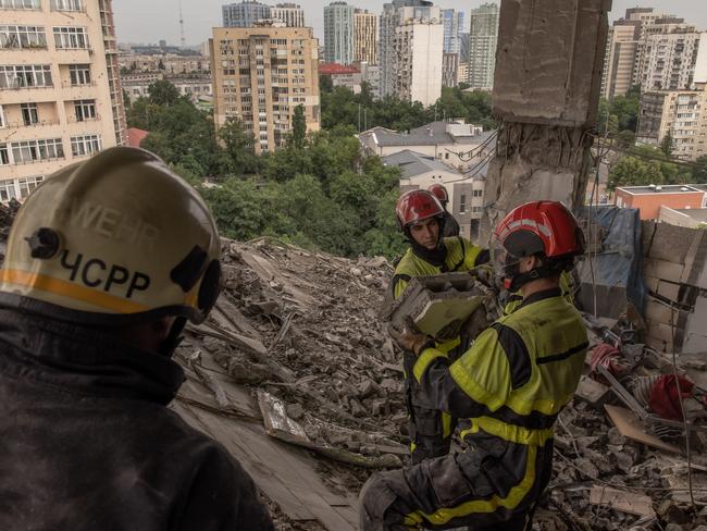 Emergency personnel clear rubble in search for victims in the heavily damaged apartment building that was hit by a downed Russian missile on June 24 in Kyiv, Ukraine. At least three people died as Russian forces fired more than 20 missiles at the Ukrainian capital before dawn on Saturday. Picture: Photo by Roman Pilipey/Getty Images