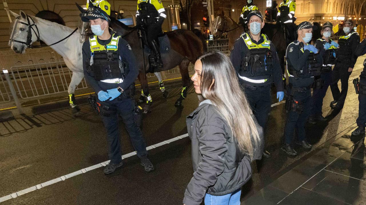 Police stood in front of parliament as protesters displayed their anger at the snap lockdown. Picture: Tony Gough