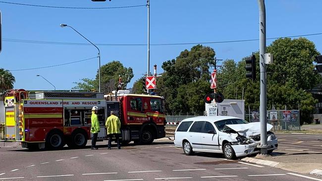 A car crash has blocked a busy intersection and halted a train this morning.