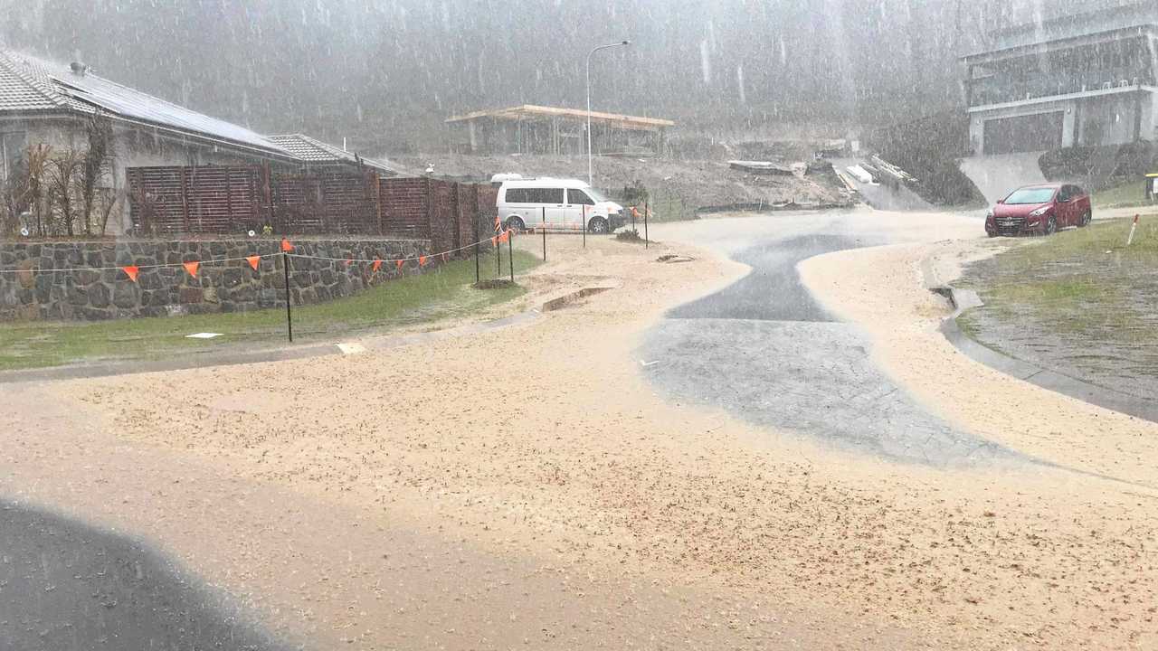 DELUGE: The downpours in mid-November sent muddy water sprawling across this street in Parklakes 2. Picture: Contributed