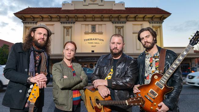 Musicians Trent Worley, Sean Kemp and Dusty Lee Stephensen with Thebby employee Amy Boman outside the Thebarton Theatre. Picture: Brenton Edwards