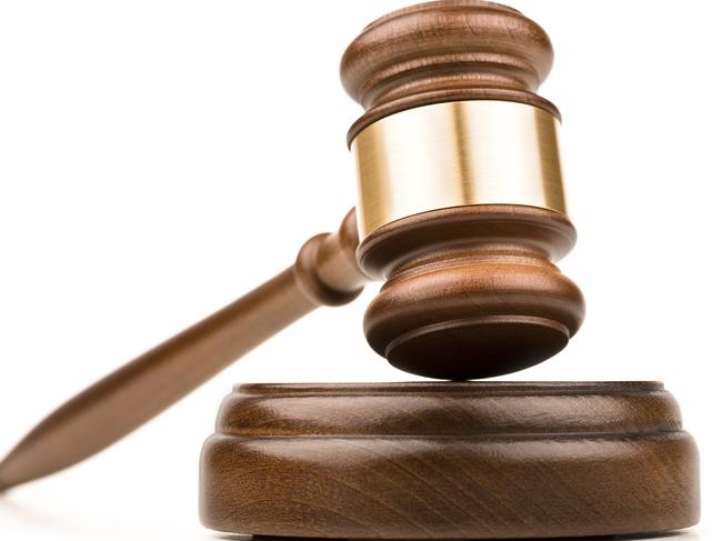 Wood gavel and sounding block on a white background.