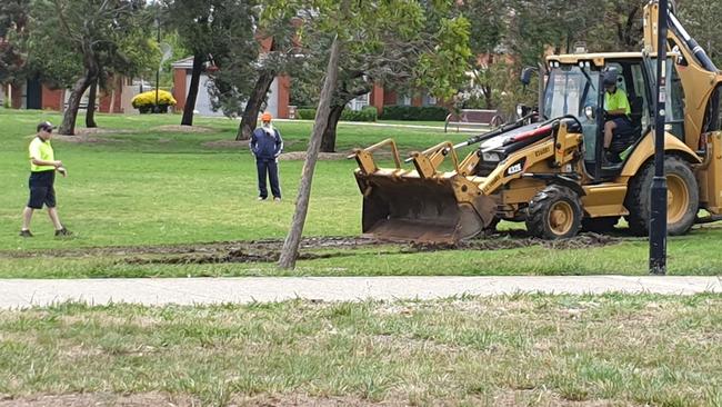 Council workers work to improve the damage to Boydon Square oval in Roxburgh Park.