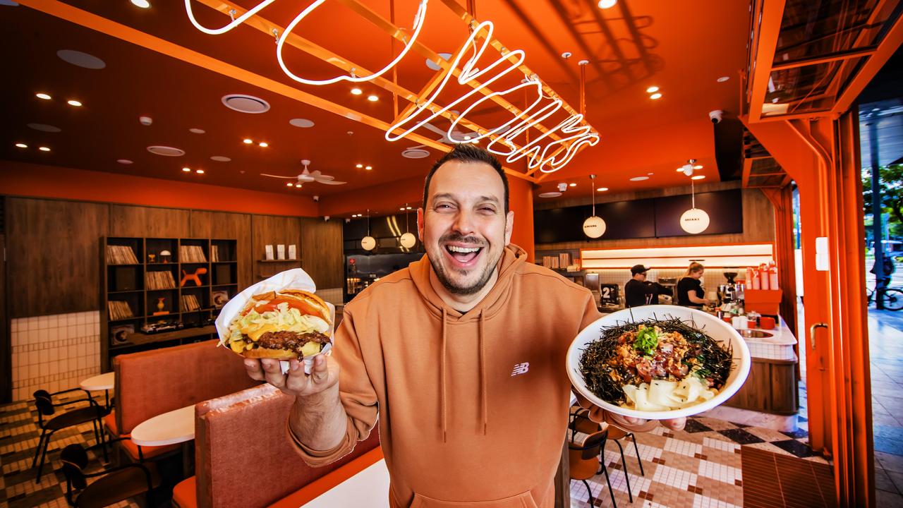 Jem Jacinto with a burger and poke bowl from his new South Bank eateries Finn Poke and Two Yolks. Picture: Nigel Hallett