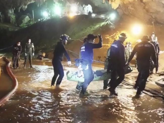 Rescuers hold an evacuated boy inside the Tham Luang Nang Non cave in Mae Sai. Picture: AP