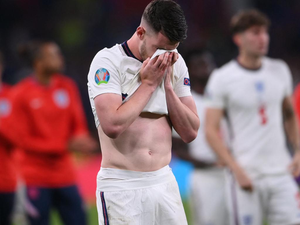 England's midfielder Declan Rice reacts to the loss.