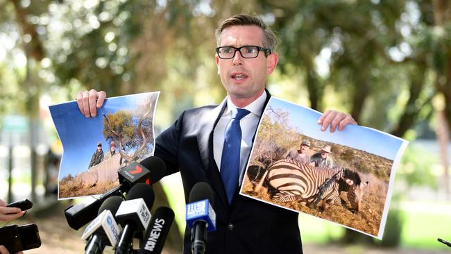 NSW Treasurer Dominic Perrottet holds aloft images of Shooters Party MP Robert Borsak during a press conference earlier this month. Picture: AAP Image/Joel Carrett